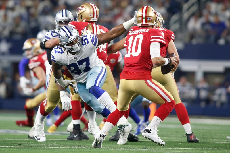 Jan 16, 2022; Arlington, Texas, USA; Dallas Cowboys defensive tackle Osa Odighizuwa (97) pressures San Francisco 49ers quarterback Jimmy Garoppolo (10) in a NFC Wild Card playoff football game at AT&T Stadium. Mandatory Credit: Tim Heitman-USA TODAY Sports