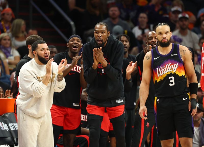 Apr 7, 2026; Phoenix, Arizona, USA; Houston Rockets injured guard Fred VanVleet (left) and forward Kevin Durant (7) celebrates alongside Phoenix Suns forward Dillon Brooks (3) in the second half at Mortgage Matchup Center. Mandatory Credit: Mark J. Rebilas-Imagn Images