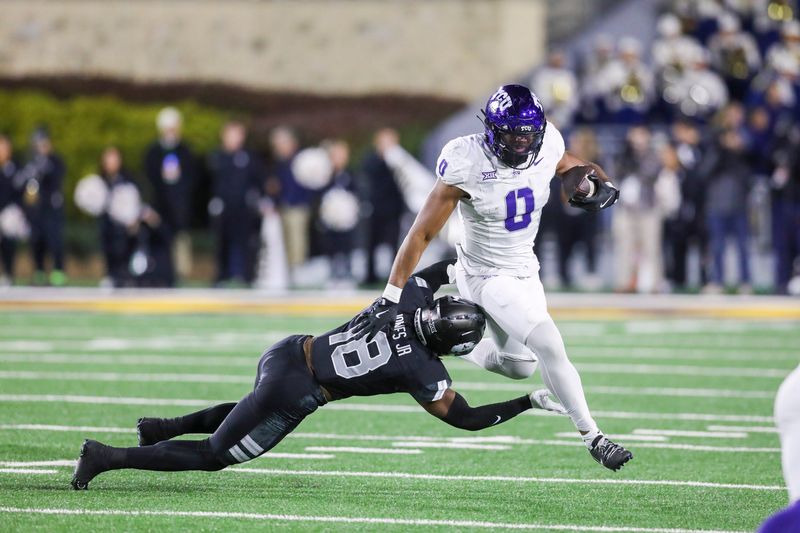 Oct 25, 2025; Morgantown, West Virginia, USA; Texas Christian University Horned Frogs tight end DJ Rogers (0) makes a catch and shakes a tackle from West Virginia Mountaineers linebacker Curtis Jones Jr. (18) during the fourth quarter at Milan Puskar Stadium. Mandatory Credit: Ben Queen-Imagn Images