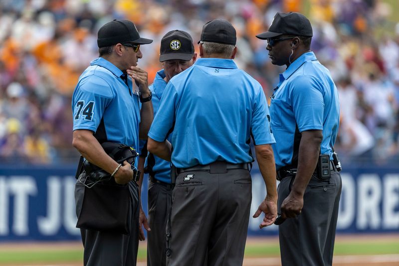 May 25, 2024; Hoover, AL, USA; The umpires convene a conference as they discuss a steal of home attempt and possible catcher’s interference during the SEC Baseball Tournament at Hoover Metropolitan Stadium. Mandatory Credit: Vasha Hunt-USA TODAY Sports