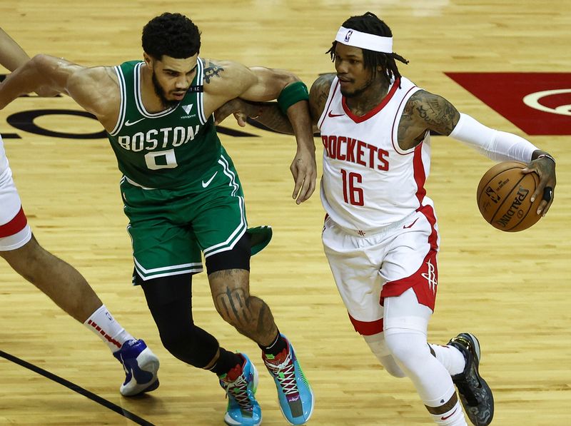 Mar 14, 2021; Houston, Texas, USA; Houston Rockets guard Ben McLemore (16) dribbles the ball as Boston Celtics forward Jayson Tatum (0) defends during the first quarter at Toyota Center. Mandatory Credit: Troy Taormina-USA TODAY Sports