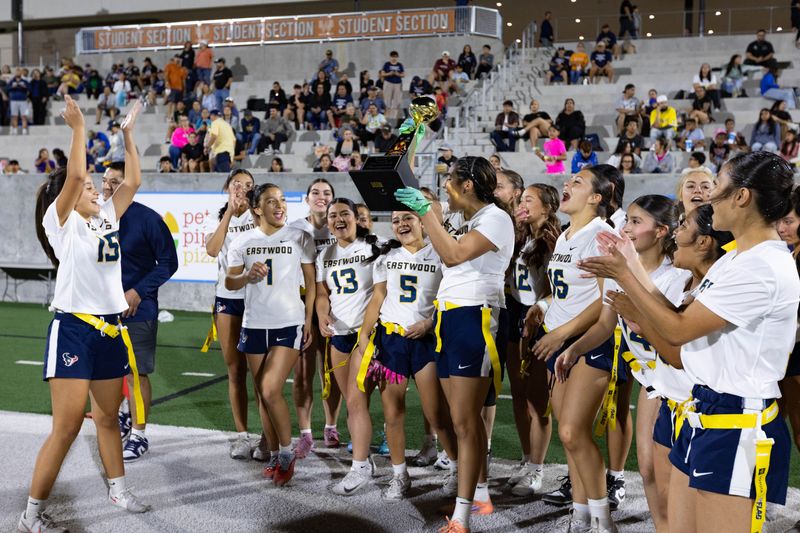 Eastwood’ Mariana Macias lifts the trophy as she celebrates with her teammates their 26-0 win against El Dorado in the Region 19 flag football Championship final game at SAC II on Wednesday, May 20, 2026.