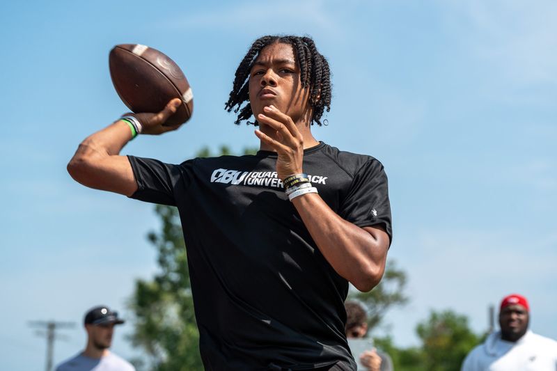 Donald Tabron II, 16, a quarterback at Cass Technical High School, throws a football during a private workout in Detroit on Saturday, June 21, 2025.
