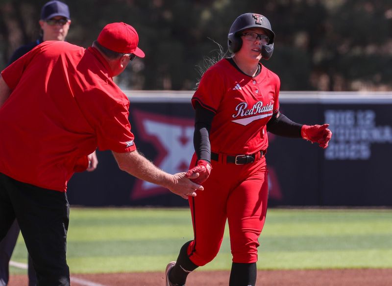 Texas Tech's Mia Williams high-fives Gerry Glasco after hitting a home rung against Texas A&M-Corpus Christi during a Division I non-conference softball game, Sunday, March 1, 2026, at Rocky Johnson Field.