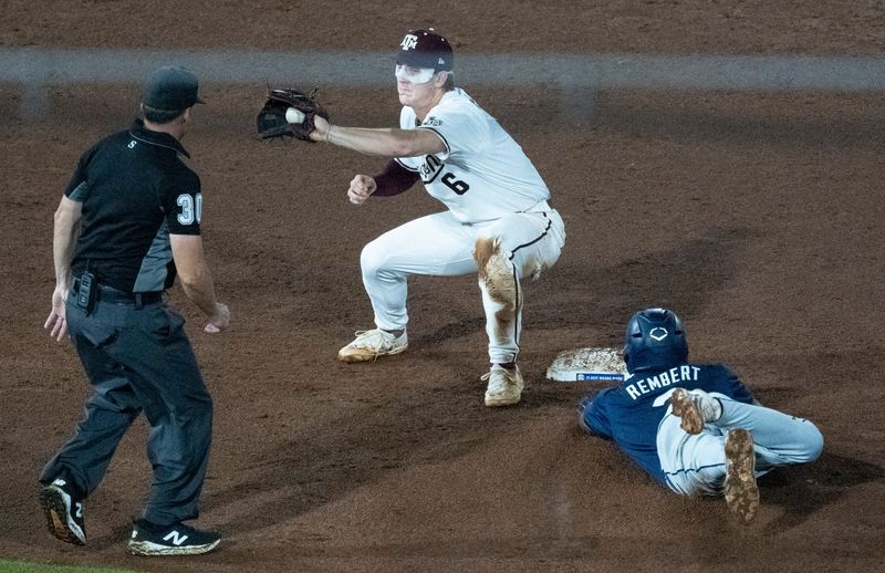 Auburn Tigers' Chris Rembert (2) dives safely into second base before Texas A&M Aggies' Boston Kellner (6) can get the tag as Auburn Tigers take on Texas A&M Aggies during the SEC baseball tournament at Hoover Metropolitan Stadium at Legacy Arena in Hoover, Ala.