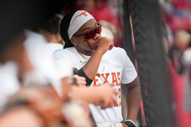 Texas infielder Victoria Hunter (12) stands in the dug out during an NCAA softball game between Oklahoma (OU) and Texas at Loveâ€™s Field in Norman. Okla., on Saturday, April 26, 2025.