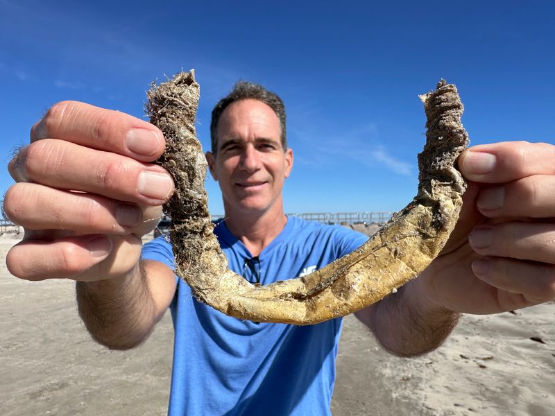 Jace Tunnell holding a parchment worm tube.