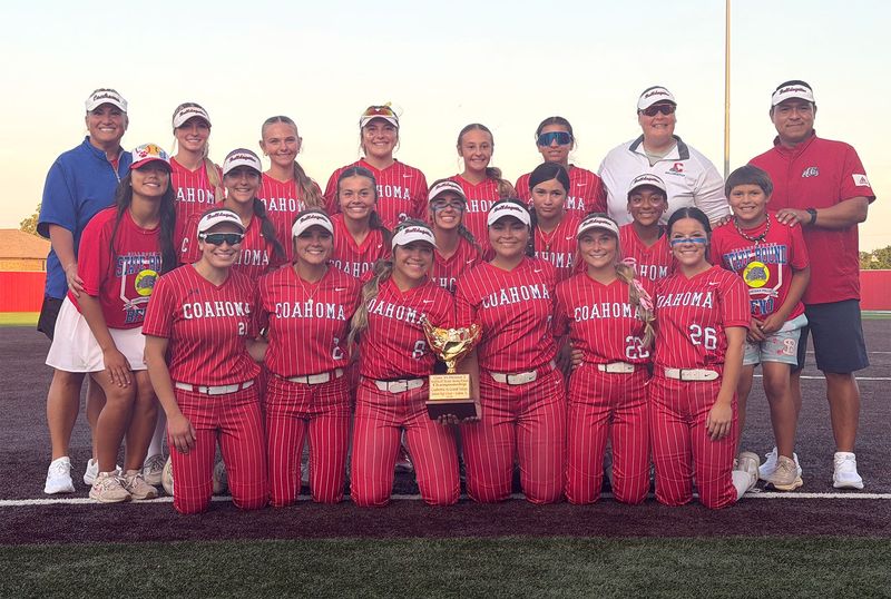 The Coahoma Bulldogettes celebrate with their trophy after beating the Grand Saline Lady Indians in the state semifinals of the 3A DII UIL Softball Playoffs on Saturday, May 23, at Hogan Field in Graham. Coahoma won 13-3 to advance to its 5th straight state title game.