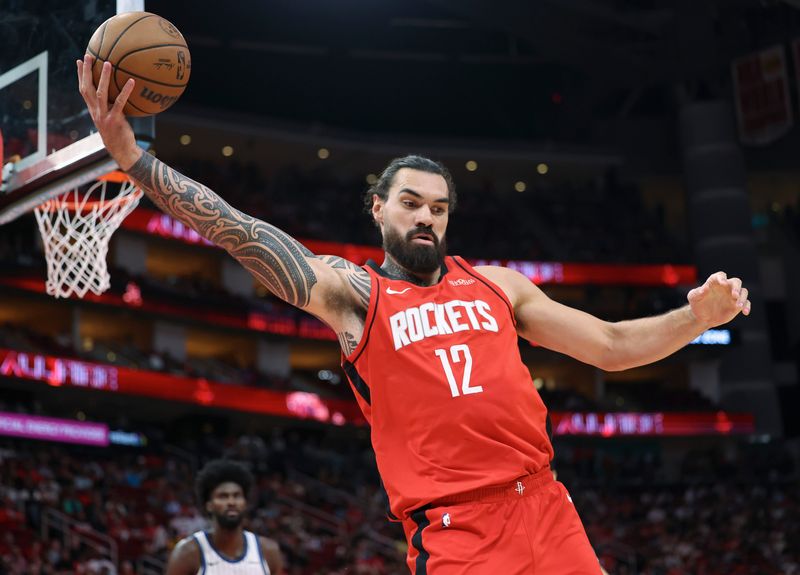 Nov 16, 2025; Houston, Texas, USA; Houston Rockets center Steven Adams (12) grabs a rebound during the first half against the Orlando Magic at Toyota Center. Mandatory Credit: Troy Taormina-Imagn Images