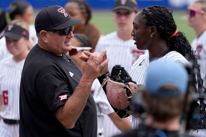 Texas Tech Red Raiders head coach Gerry Glasco talks with Texas Tech Red Raiders pitcher Nijaree Canady (24) during a Women's College World Series softball game between the Texas Tech Red Raiders and the Mississippi State Bulldogs at Devon Park in Oklahoma City, Thursday, May 28, 2026.