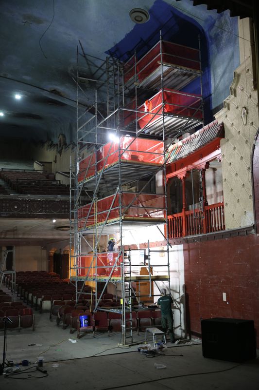 Workers from EverGreene Achitectural Arts paint a 10-foot column of the The Ritz Theatre in original colors on May 29, 2026.