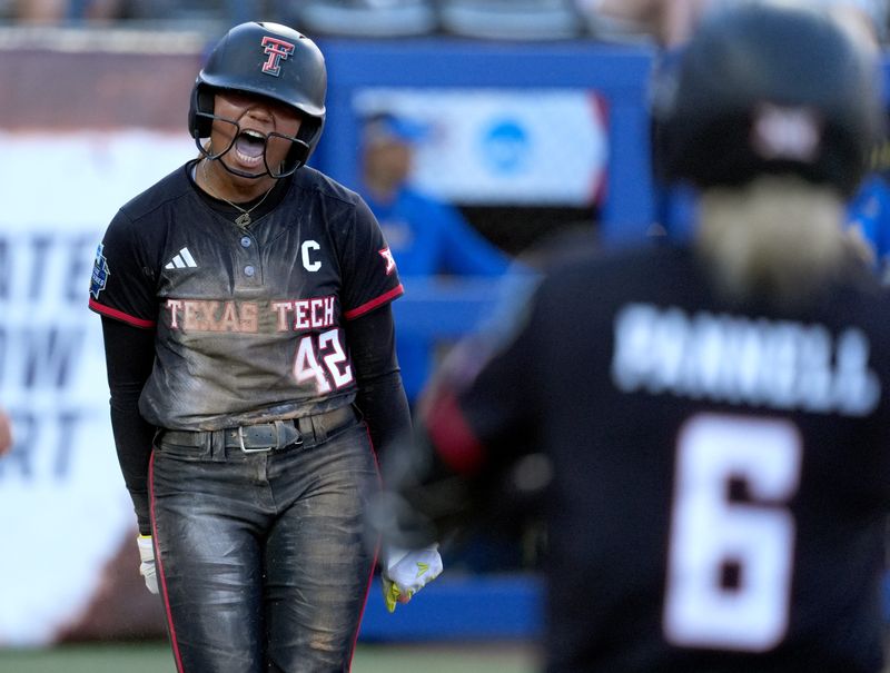 Texas Tech's Mihyia Davis (42) celebrates a score in the sixth inning of a Women's College World Series softball game between Texas Tech Red Raiders and the UCLA Bruins at Devon Park in Oklahoma City, May 31, 2026.
