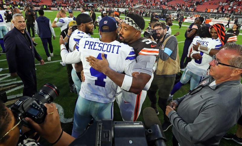 Cleveland Browns defensive end Myles Garrett, facing, hugs Dallas Cowboys quarterback Dak Prescott and linebacker Micah Parsons after losing to the Cowboys in an NFL football game at Huntington Bank Field, Sunday, Sept. 8, 2024, in Cleveland, Ohio.