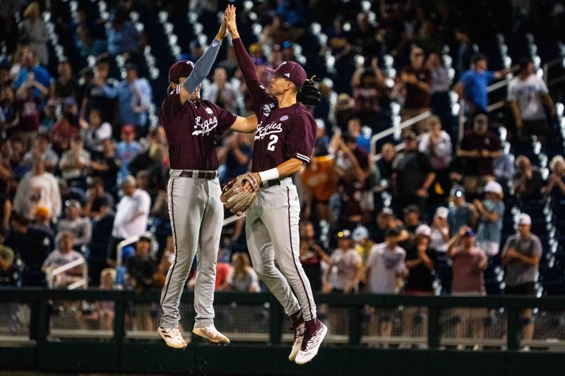 Jun 19, 2024; Omaha, NE, USA; Texas A&M Aggies second baseman Jack Bell (1) and shortstop Ali Camarillo (2) celebrate after defeating the Florida Gators to make it to the championship at Charles Schwab Field Omaha. Mandatory Credit: Dylan Widger-USA TODAY Sports
