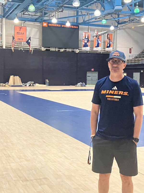 UTEP volleyball coach Ben Wallis stands on the new Teraflex flooring currently being installed in Memorial Gym.
