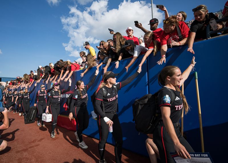 Jun 3, 2026; Oklahoma City, OK, USA; Texas Tech Red Raiders players enter the stadium before game one of the NCAA Women’s College World Series championship series against the Texas Longhorns at Devon Park. Mandatory Credit: Brett Rojo-Imagn Images
