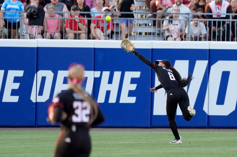 The ball gets past Texas Tech Red Raiders utility Desirae Spearman (8) in the first inning of Game 1 of the NCAA softball Women's College World Series finals between the Texas Longhorns and the Texas Tech Red Raiders at Devon Park in Oklahoma City, Wednesday, June 3, 2026.