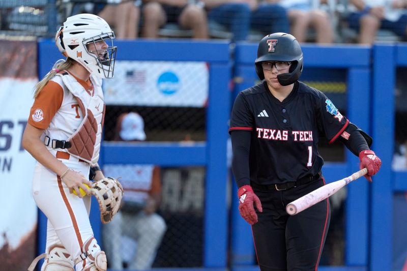 Texas Tech Red Raiders second baseman Mia Williams (1) strikes out as Texas Longhorns utility Reese Atwood (14) celebrates in the third inning of Game 1 of the NCAA softball Women's College World Series finals between the Texas Longhorns and the Texas Tech Red Raiders at Devon Park in Oklahoma City, Wednesday, June 3, 2026.