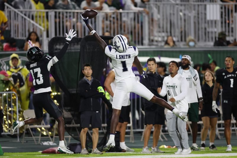 Oct 26, 2024; Honolulu, Hawaii, USA; Nevada Wolf Pack wide receiver Jaden Smith (1) attempts to make a catch over Hawaii Rainbow Warriors defensive back Caleb Brown (13) during the second quarter at the Clarence T.C. Ching Athletics Complex. Smith caught the ball out of bounds. Mandatory Credit: Marco Garcia-Imagn Images