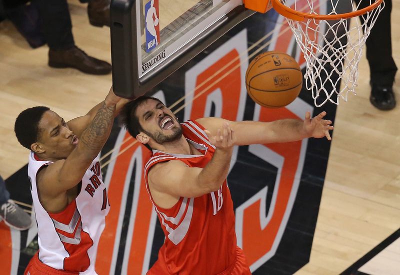 Apr 2, 2014; Toronto, Ontario, CAN; Toronto Raptors guard DeMar DeRozan (10) fouls Houston Rockets forward Omri Casspi (18) at Air Canada Centre. The Raptors beat the Rockets 107-103. Mandatory Credit: Tom Szczerbowski-USA TODAY Sports