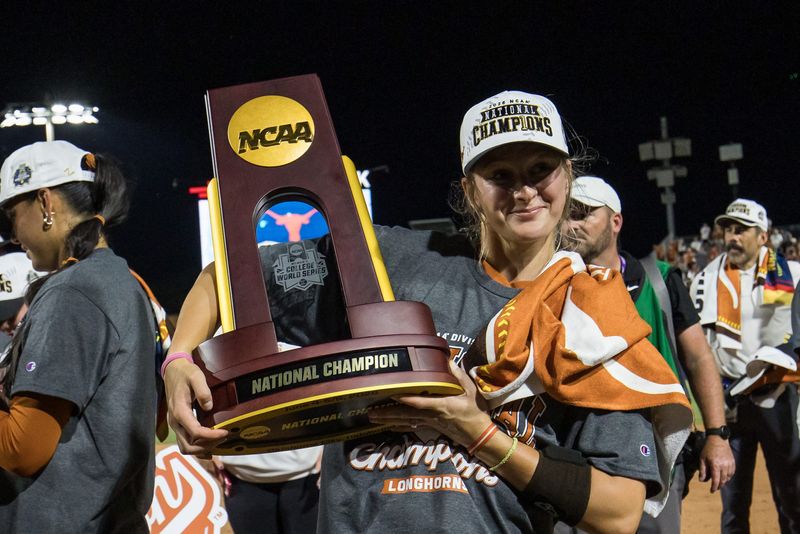 Jun 4, 2026; Oklahoma City, OK, USA; Texas Longhorns outfielder Ashton Maloney (7) poses for a photo with the NCAA national championship trophy after defeating the Texas Tech Red Raiders to win the NCAA WomenÕs College World Series championship series at Devon Park. Mandatory Credit: Brett Rojo-Imagn Images