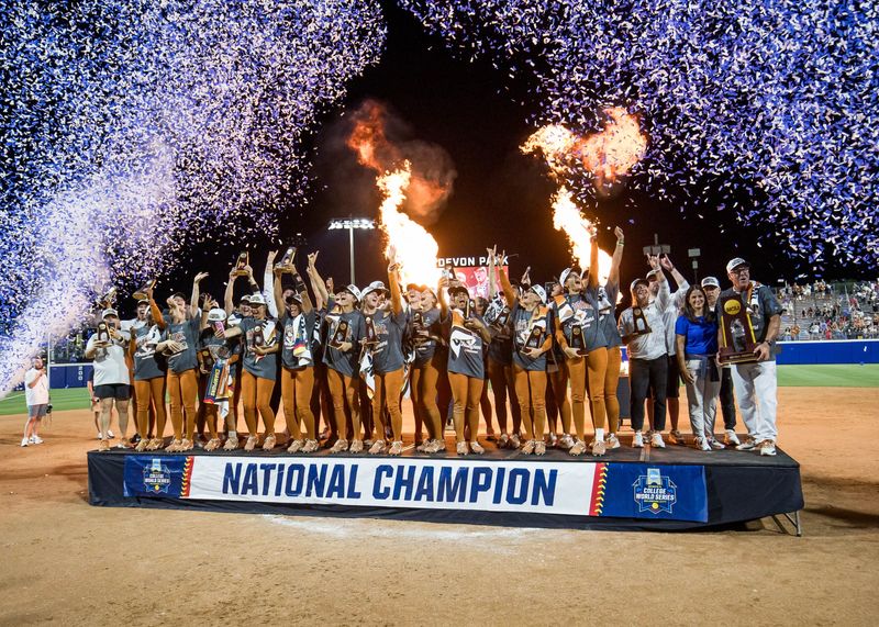 Jun 4, 2026; Oklahoma City, OK, USA; Texas Longhorns players and coaches pose for a group photo after defeating the Texas Tech Red Raiders to win the NCAA WomenÕs College World Series championship series at Devon Park. Mandatory Credit: Brett Rojo-Imagn Images