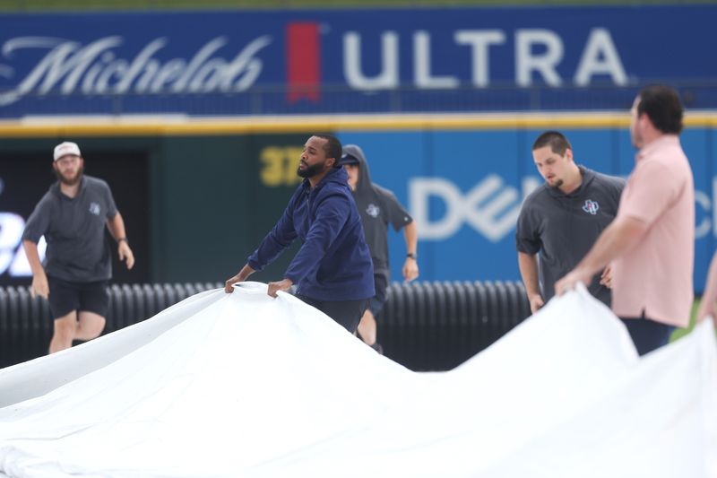 Grounds crew members pull the tarp onto the field during the Class 4A Division I baseball state championship game between Calallen and Pleasant Grove at Dell Diamond in Round Rock on Friday, June 5, 2026.