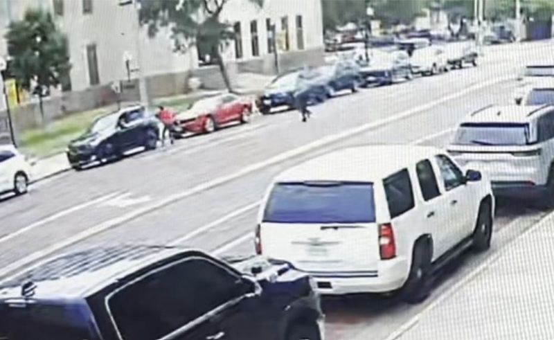 This surveillance image provided by the U.S. Department of Justice shows what federal investigators say was a man they identified as Isaiah Joshua Lee Houston forcibly removing a woman from a black SUV during an attempted carjacking May 29 in Lubbock.