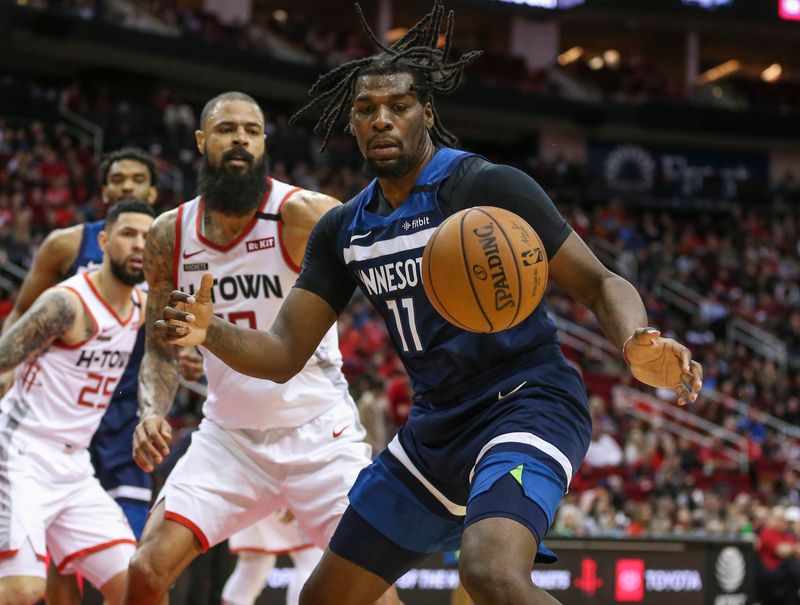 Jan 11, 2020; Houston, Texas, USA; Minnesota Timberwolves center Naz Reid (11) attempts to keep control of the ball away from Houston Rockets center Tyson Chandler (19) during the fourth quarter at Toyota Center. Mandatory Credit: Troy Taormina-USA TODAY Sports