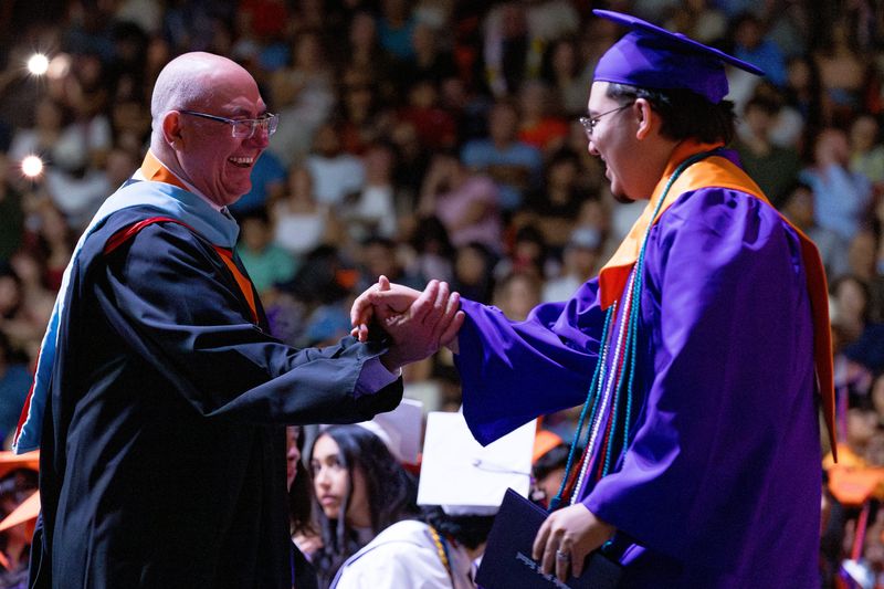 Eastlake High School Principal Gilbert Martinez shares a laugh with a graduate during the commencement ceremony Saturday, June 6, 2026, at the Don Haskins Center in El Paso, Texas.