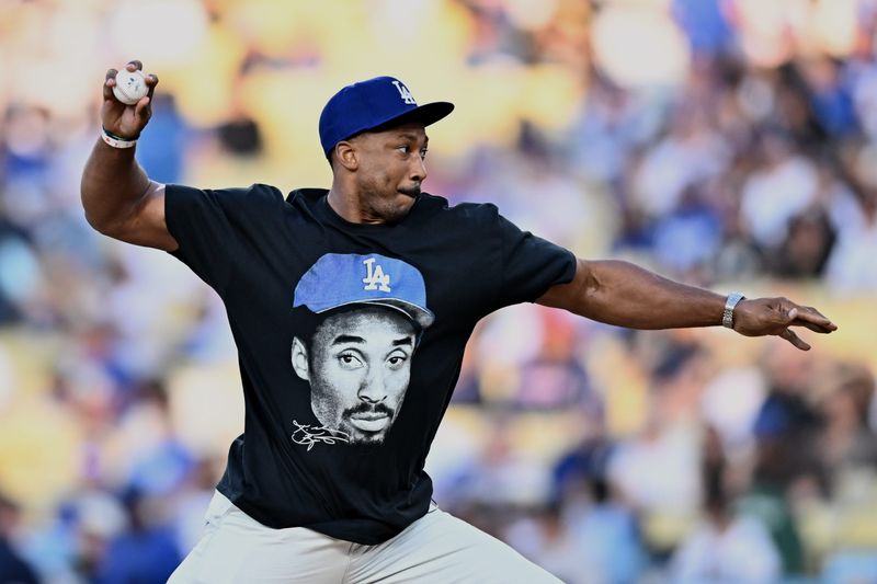 Jun 6, 2026; Los Angeles, California, USA; Los Angeles Rams defensive end Myles Garrett throws out the honorary first pitch before a game between the Los Angeles Angels and Los Angeles Dodgers at Dodger Stadium. Mandatory Credit: William Liang-Imagn Images