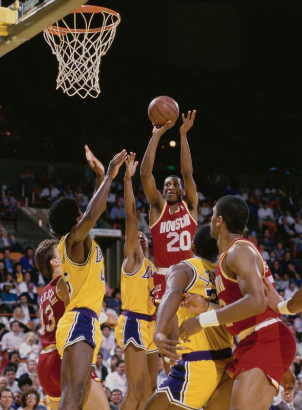 Steve Harris #20, Shooting Guard for the Houston Rockets makes a one handed shot to the basket over the Los Angeles Lakers defense during their NBA Pacific Division basketball game on 31st March 1987 at The Forum arena in Inglewood, Los Angeles, California, United States. The Lakers won the game 111 - 96. (Photo by Mike Powell/Allsport/Getty Images)