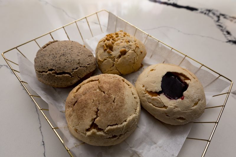 A basket of raspberry, churro, peanut and coffee conchas is prepared at Doka Brunch on Friday, June 12, 2026, in El Paso, Texas. The restaurant, located at 6006 N. Mesa St., Suite 106, opened in September 2025.