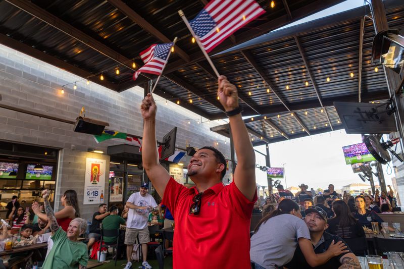 The city of El Paso will have a World Cup community watch party for the USA vs. Turkiye game on June 25 at Cleveland Square in Downtown El Paso. A  fan waves U.S. flags in support of Team USA in the World Cup match against Paraguay at Shack Wings & Brew restaurant in El Paso on June 12 in this photo.