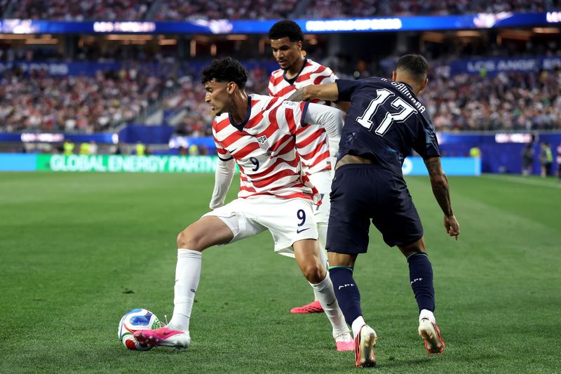 Ricardo Pepi #9 of the United States is challenged by Alejandro Romero Gamarra #17 of Paraguay during the FIFA World Cup 2026 Group D match between USA and Paraguay at Los Angeles Stadium on June 12, 2026 in Los Angeles, California.