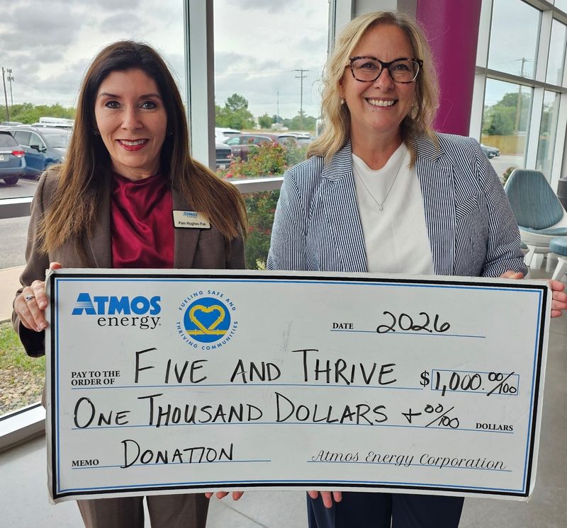 Atmos Energy Manager of Public Affairs Pam Hughes Pak, left, presents a $1,000 donation to Pam Peterson, chief operating officer for the Five and Thrive Program at Sheppard Air Force Base.
