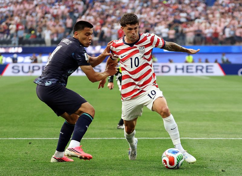 June 12, 2026; Inglewood, California, U.S.; Christian Pulisic of the U.S. in action with Paraguay's Diego Gomez. Mandatory Credit: Kiyoshi Mio-Imagn Images