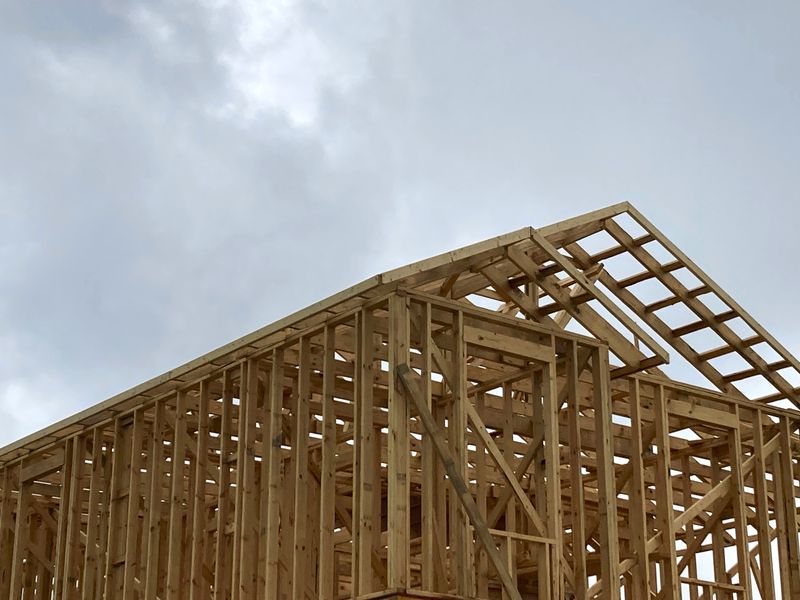 A new house is shown under construction.