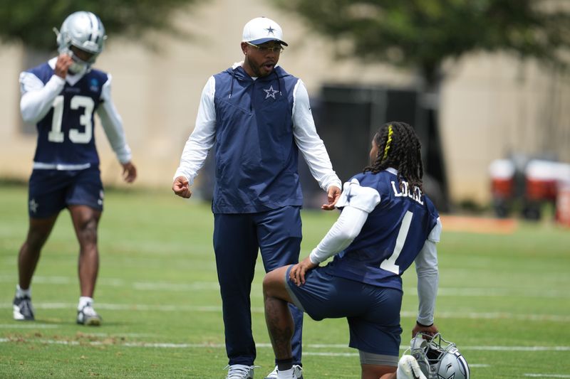 Jun 16, 2026; Dallas, TX, USA; Dallas Cowboys defensive coordinator Christian Parker speaks with wide receiver PJ Locke (1) during practice at the Ford Center at the Star Training Facility in Frisco, Texas. Mandatory Credit: Chris Jones-Imagn Images