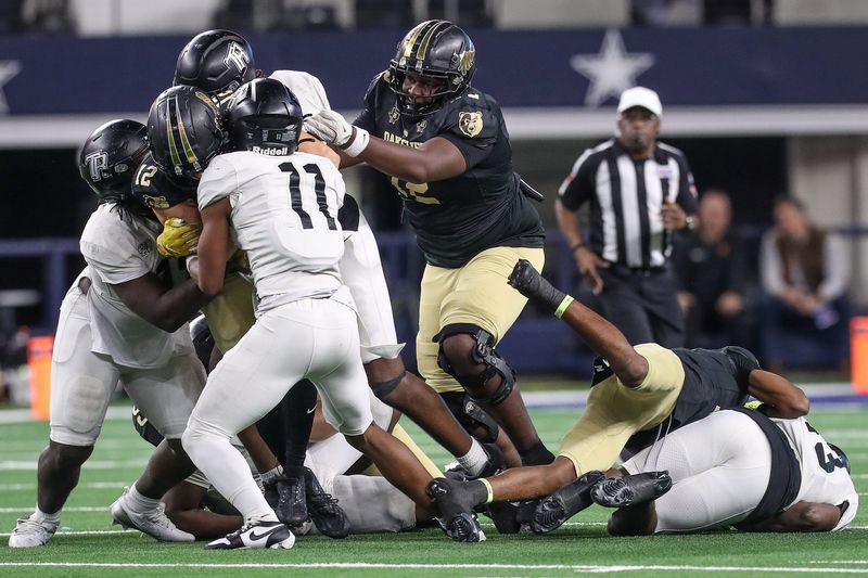 South Oak Cliff's Brian Swanson (72) attempts to free quarterback Carter Kopecky (12) during the Class 5A, Division II State Championship game on Friday, Dec. 20, 2024, at AT&T Stadium in Arlington, Texas.