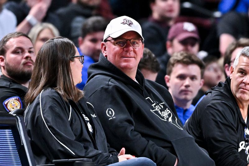 Feb 7, 2026; College Station, Texas, USA; Texas A&M Aggies head football coach Mike Elko sits court side during the Men’s basketball game against the Florida Gators at Reed Arena. Mandatory Credit: Maria Lysaker-Imagn Images