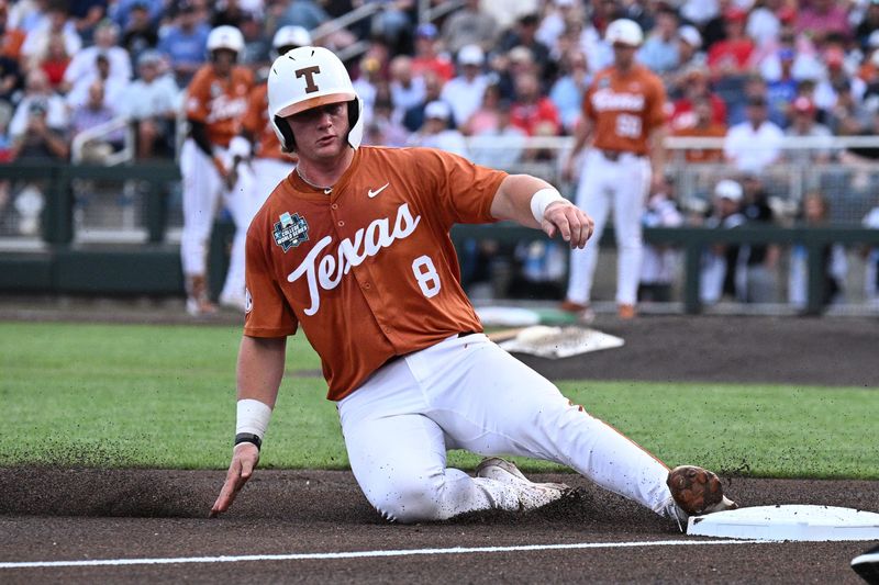Jun 16, 2026; Omaha, NE, USA;  Texas Longhorns catcher Carson Tinney (8) slides into third base against the Georgia Bulldogs during the first inning at Charles Schwab Field. Mandatory Credit: Steven Branscombe-Imagn Images