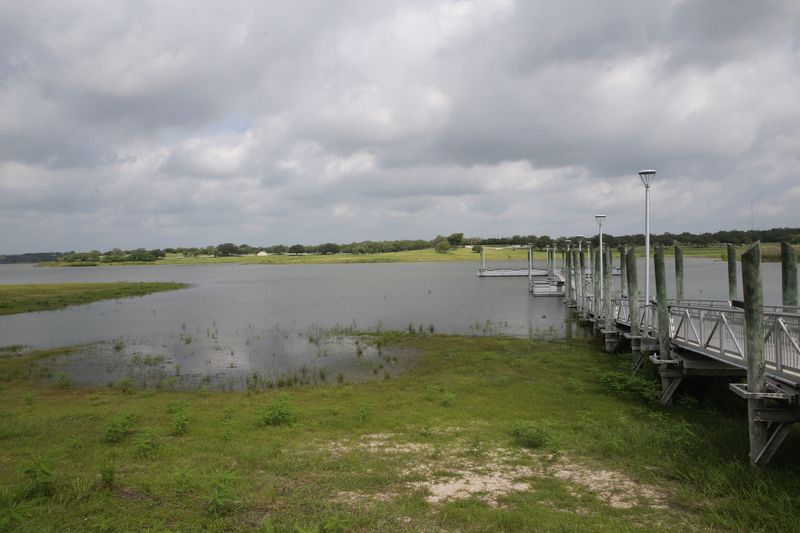 Water inches up from what had been dry land at Lake Corpus Christi on June 19, 2026. The lake was 30% full.