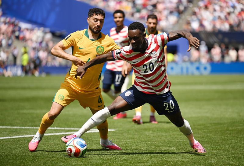 June 19, 2026; Seattle, Washington, U.S.; Folarin Balogun of the U.S. in action with Australia's Jacob Italiano.  Mandatory Credit: Troy Wayrynen-Imagn Images
