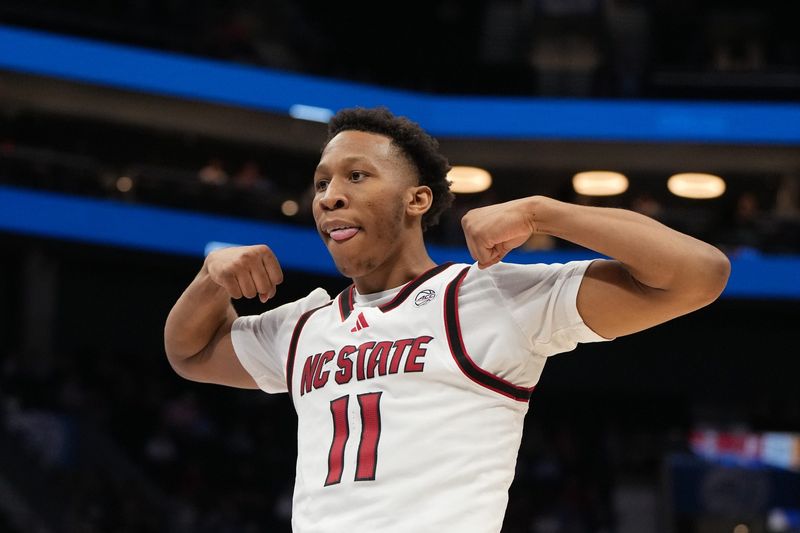 Mar 11, 2026; Charlotte, NC, USA; NC State Wolfpack guard Quadir Copeland (11) reacts after scoring in the second half at Spectrum Center. Mandatory Credit: Bob Donnan-Imagn Images