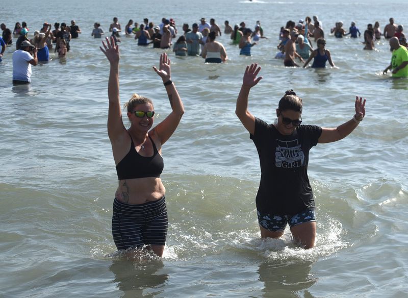 In this 2022 file photo, people wade in Corpus Christi Bay during the Corpus Christi Polar Bear Plunge on New Year's Day.