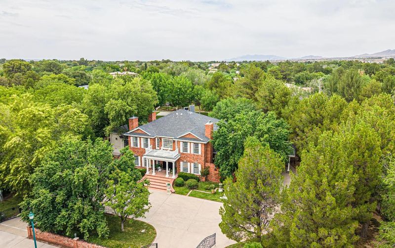 The majestic mansion at 501 Country Club Road is tucked among mature trees, creating the feeling of stepping out of the desert and into a lush oasis. The elegant estate is currently on the market for 1.25 million.