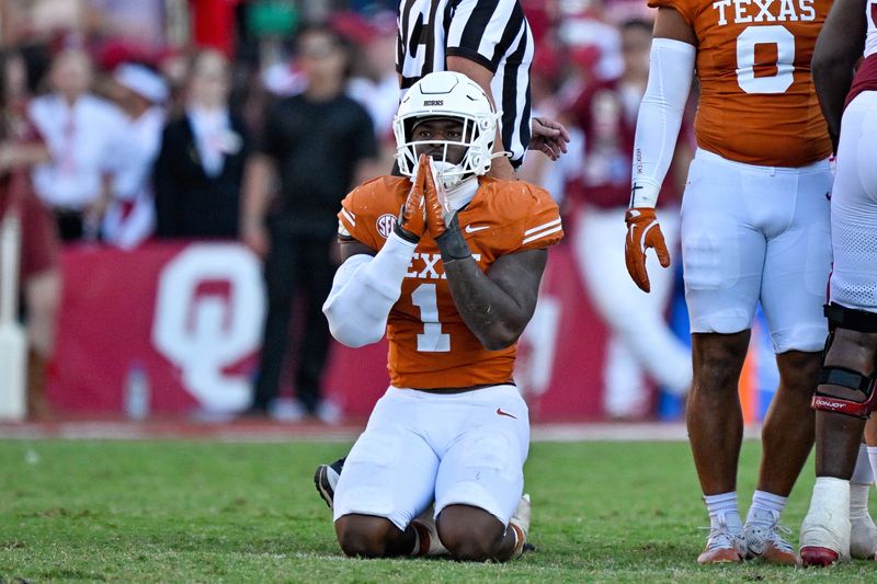 Oct 11, 2025; Dallas, Texas, USA; Texas Longhorns defensive end Colin Simmons (1) kneels on the field after the Longhorns stop the Oklahoma Sooners during the second half at the Cotton Bowl. Mandatory Credit: Jerome Miron-Imagn Images