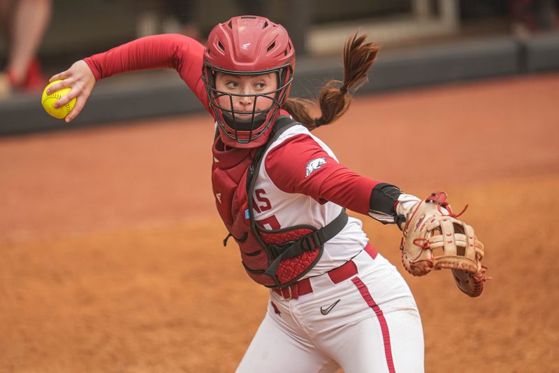 May 7, 2025; Athens, GA, USA; Arkansas catcher Kennedy Miller (17) throws to first base after a dropped third strike against Georgia at Jack Turner Stadium. Mandatory Credit: Dale Zanine-Imagn Images