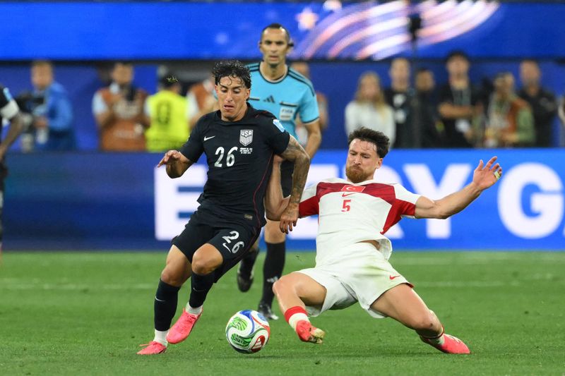US forward #26 Alex Zendejas and Turkey's midfielder #05 Salih Ozcan fight for the ball during the 2026 World Cup Group D football match between Turkey and USA at the Los Angeles Stadium in Inglewood on June 25, 2026.